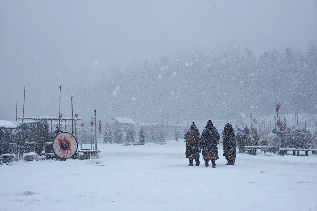 雪中の戦士たちの戦場背景｜吹雪の中を歩く戦士たちを描いた戦場背景。雪と寒さが視界を覆い、厳しい自然と戦の緊張感を静かに伝える。重厚でドラマチックな空気感が特徴。