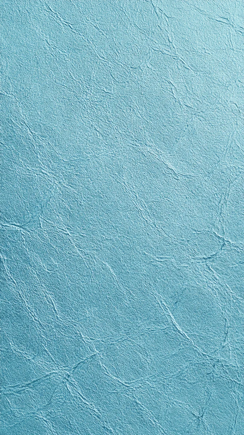 水色のシンプル壁紙 細やかな陰影｜繊細な凹凸の流れが全体に広がる水色のシンプル壁紙。光の当たり具合によって濃淡が浮かび上がり、上品な奥行きを感じさせる。