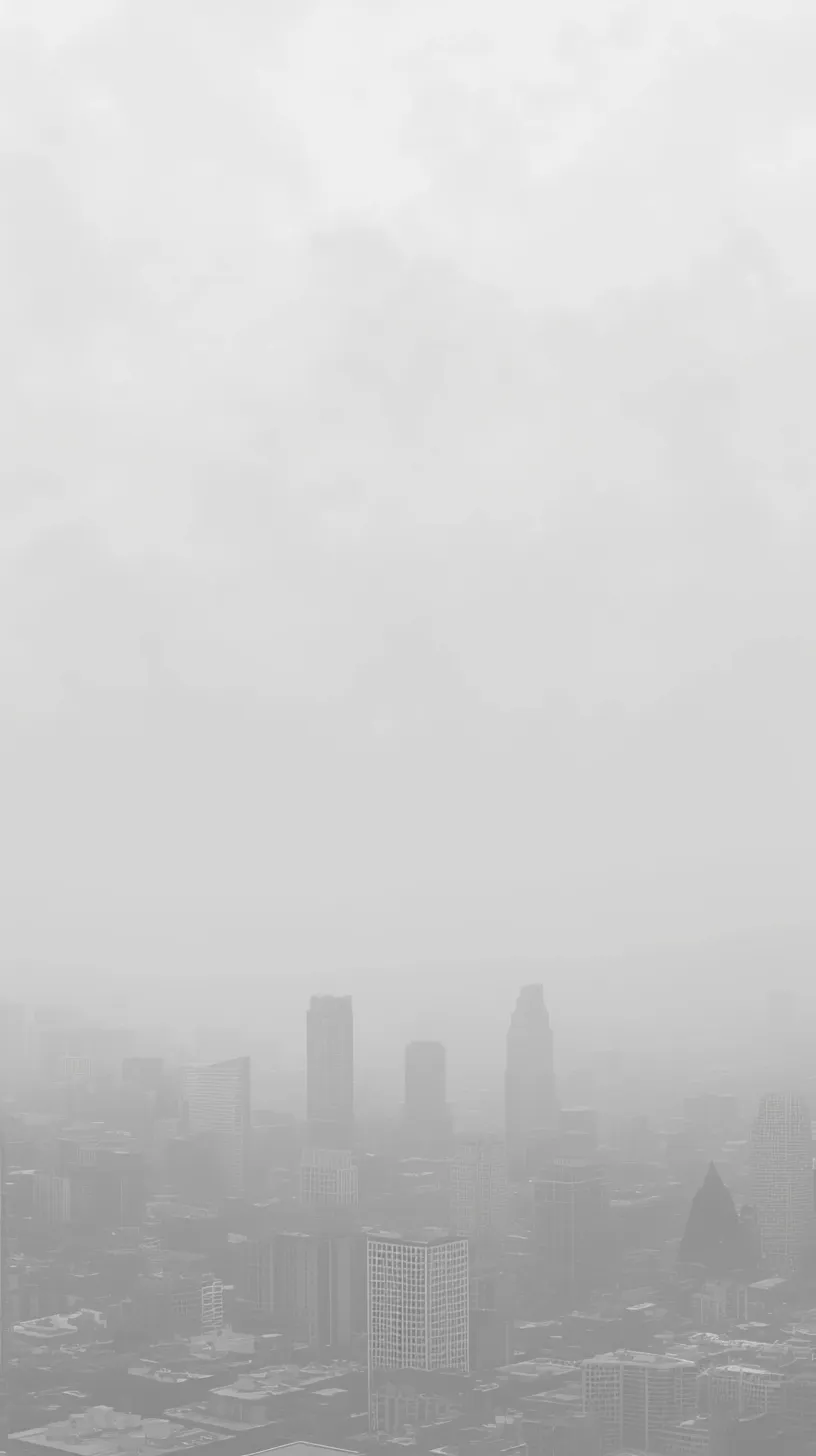霧に包まれた都市のおしゃれグレー壁紙｜霧に包まれた都市のシルエットが幻想的な雰囲気を醸し出すスマホ壁紙です。モノクロームの色調がシックな印象を与え、都会的で洗練された美しさを表現しています。静寂と神秘が同居するこのおしゃれグレー壁紙は、都会の魅力を感じさせる一枚です。